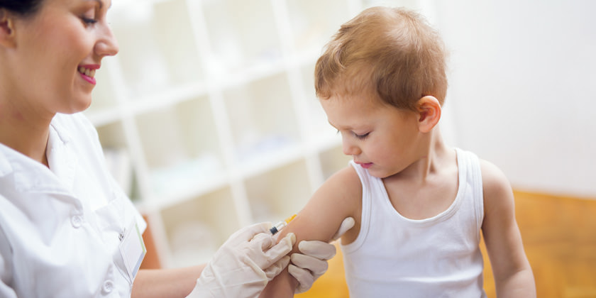 Enfermera poniéndole una vacuna a un niño